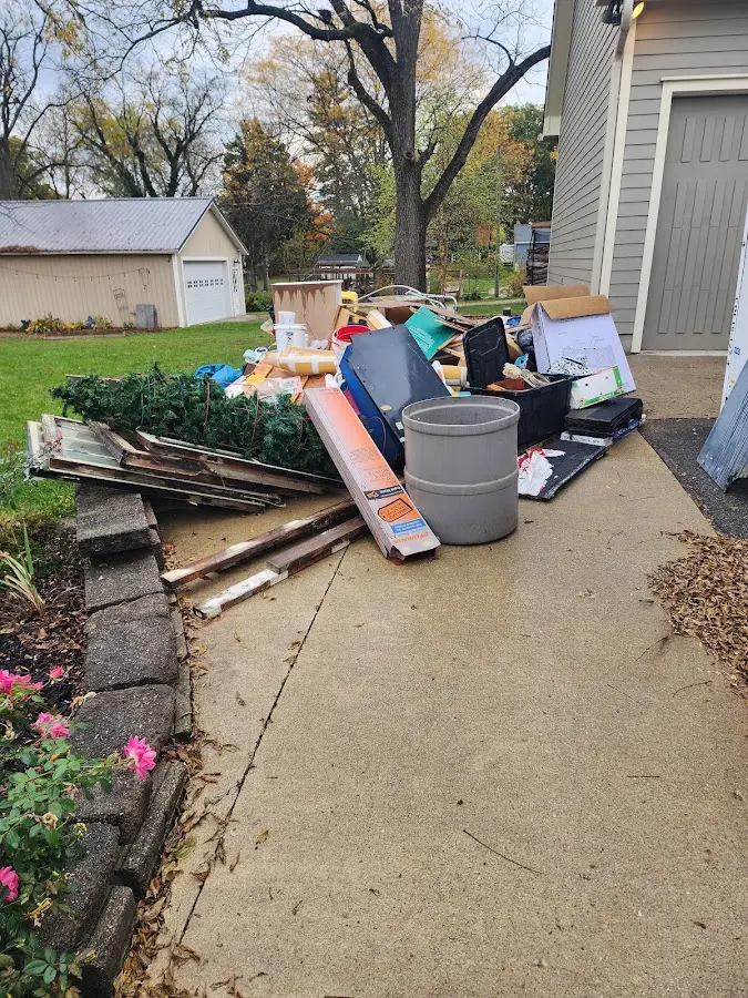 Dumpster being loaded with debris for Roofing Dumpster Rental in Greenport
